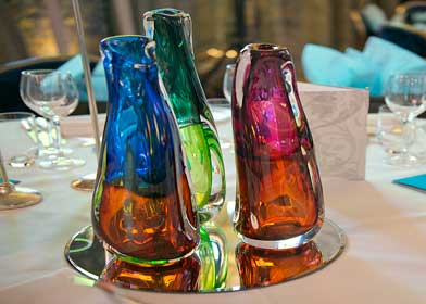A table adorned with vibrant vases in various colors, showcasing a lively and decorative arrangement at the SBID Awards.