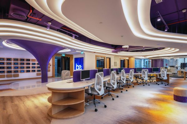 An office featuring stylish purple and white furniture, creating a modern and vibrant workspace atmosphere.